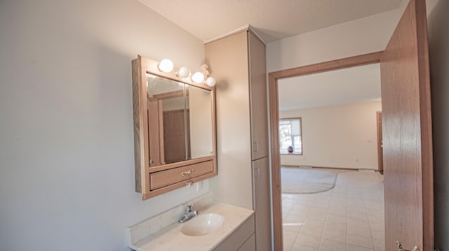 bathroom with vanity and a textured ceiling