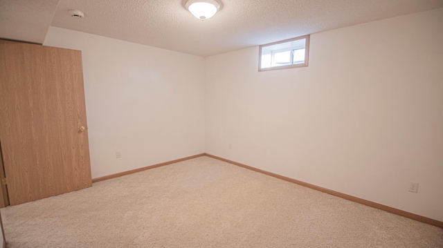 basement with light carpet and a textured ceiling