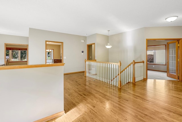 unfurnished room featuring a textured ceiling and light hardwood / wood-style flooring