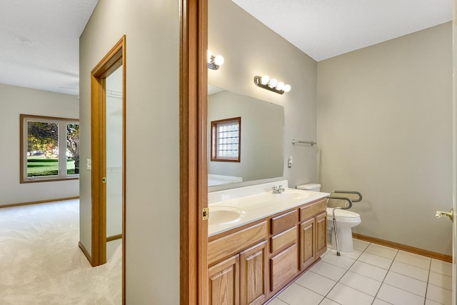 bathroom featuring tile patterned flooring, vanity, toilet, and a textured ceiling