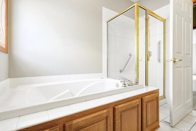 bathroom with separate shower and tub and tile patterned floors