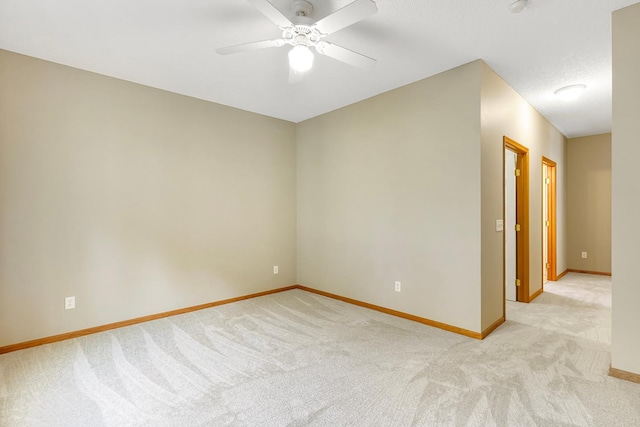 carpeted spare room featuring ceiling fan and a textured ceiling