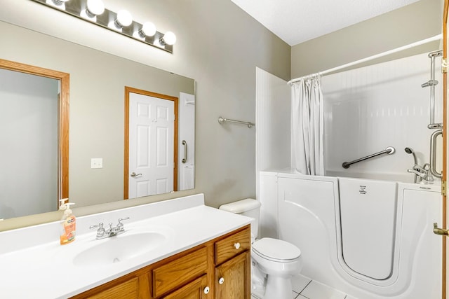 bathroom featuring tile patterned flooring, vanity, toilet, and a textured ceiling