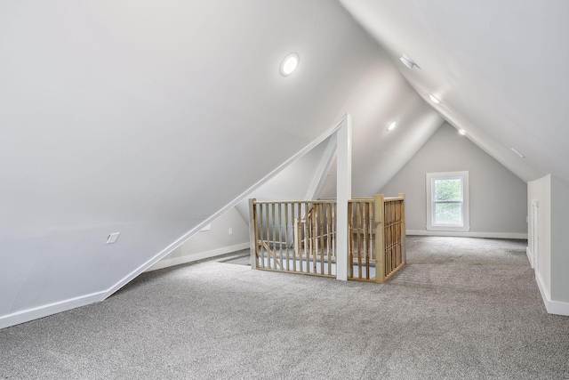 bonus room featuring carpet, vaulted ceiling, and baseboards