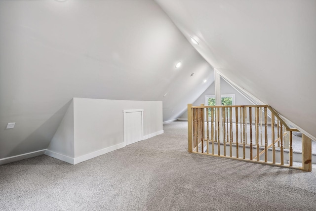 bonus room featuring lofted ceiling, baseboards, and carpet flooring