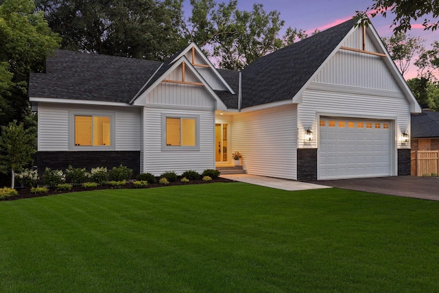 view of front of property with a lawn and a garage