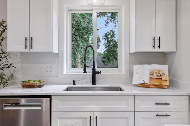 kitchen featuring white cabinetry, dishwasher, plenty of natural light, and sink