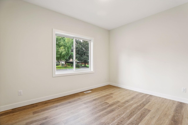 unfurnished room with light hardwood / wood-style floors