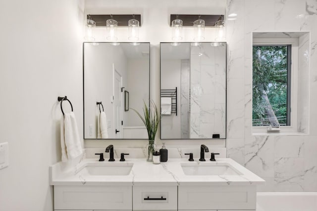 bathroom with a tub to relax in and vanity