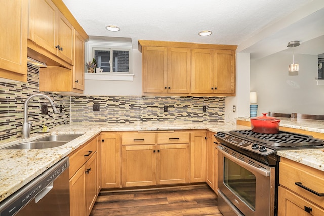 kitchen with dark wood-type flooring, sink, appliances with stainless steel finishes, tasteful backsplash, and decorative light fixtures