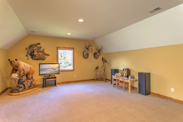 interior space with light carpet and vaulted ceiling