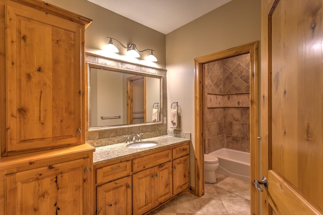 full bathroom with toilet, vanity, tile patterned floors, and tiled shower / bath