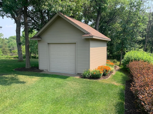 garage featuring a lawn