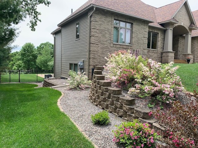 view of side of property with a lawn