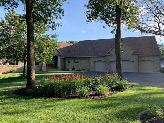 view of front of home featuring a front yard and a garage