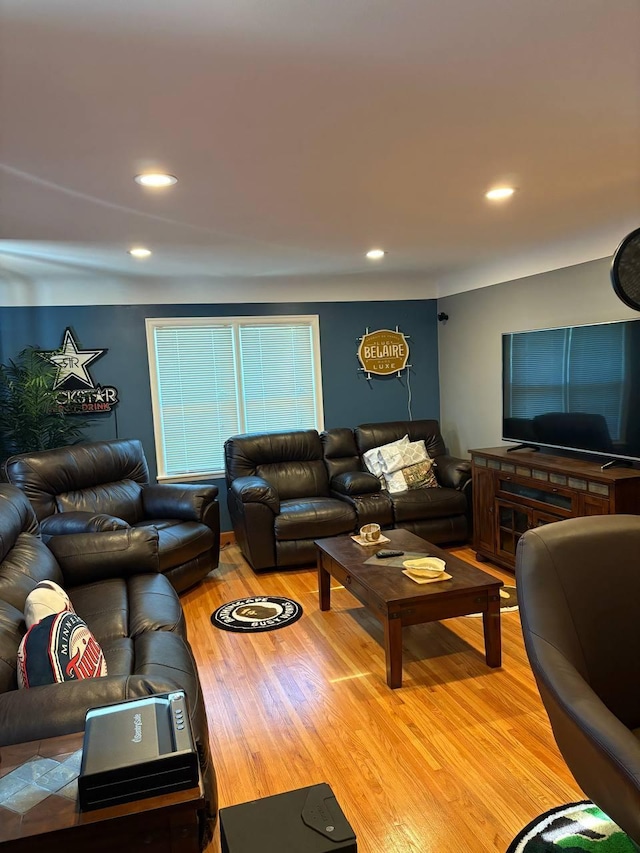 living area with light wood-style flooring and recessed lighting