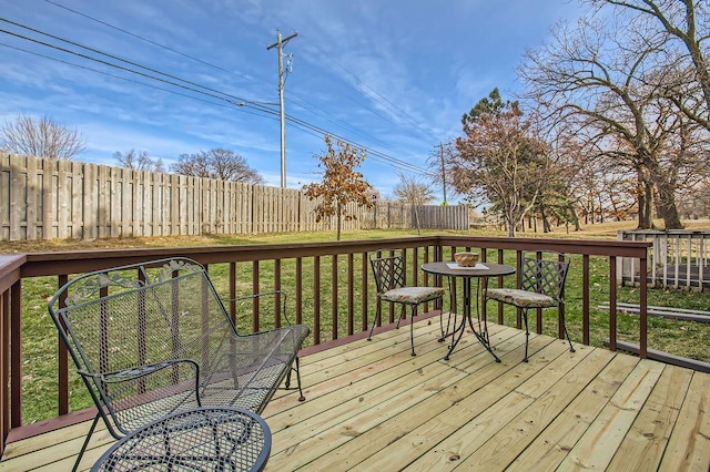 wooden deck with a lawn