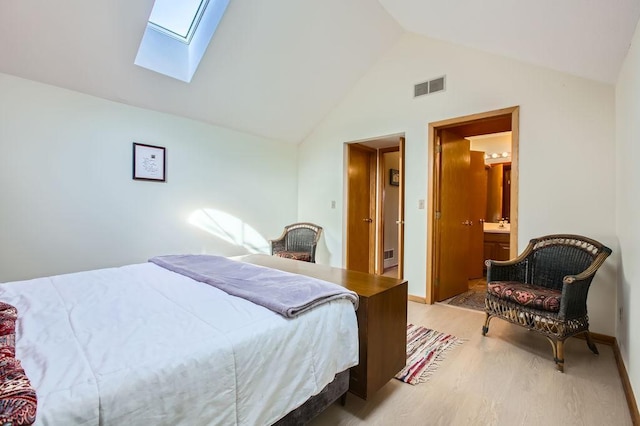 bedroom with ensuite bathroom, a skylight, high vaulted ceiling, and light wood-type flooring