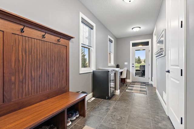 mudroom featuring a textured ceiling