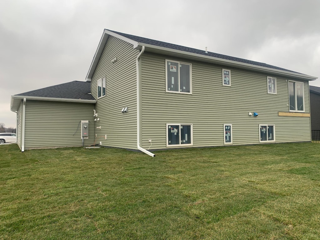 back of house with a lawn