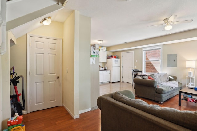 living room featuring hardwood / wood-style flooring, ceiling fan, and electric panel