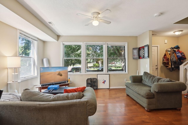 living room with hardwood / wood-style floors, a wealth of natural light, and ceiling fan