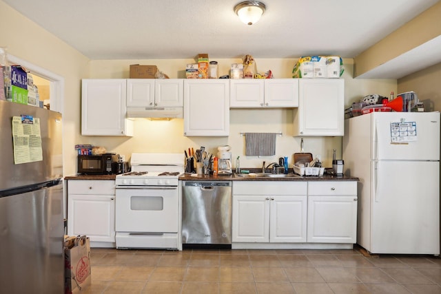 kitchen with white cabinets, light tile patterned floors, stainless steel appliances, and sink