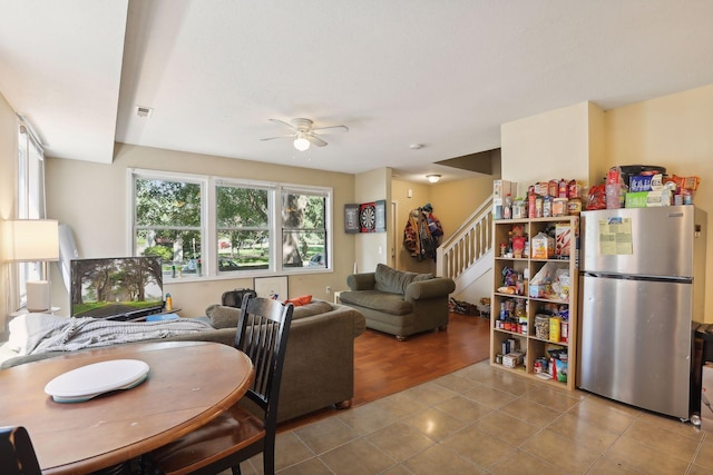 dining space with light hardwood / wood-style flooring and ceiling fan