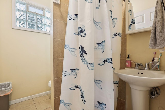 bathroom with tile patterned flooring, curtained shower, and toilet