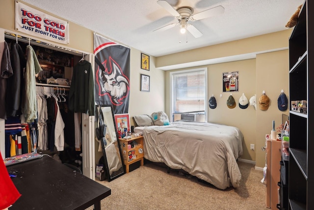 bedroom featuring a textured ceiling, a closet, ceiling fan, and light colored carpet