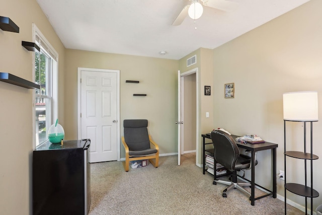 office area featuring ceiling fan and light carpet