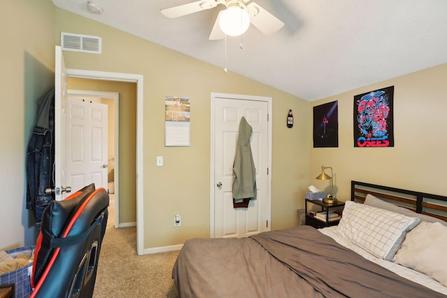 carpeted bedroom with ceiling fan and vaulted ceiling