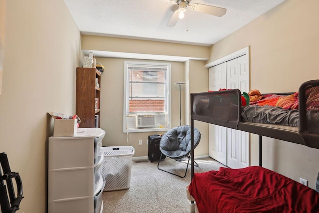 bedroom with a textured ceiling, ceiling fan, cooling unit, and light carpet