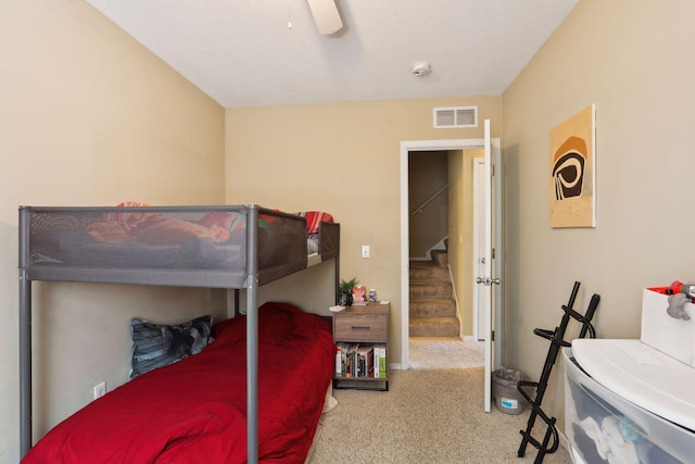 bedroom featuring carpet flooring, ceiling fan, and a textured ceiling