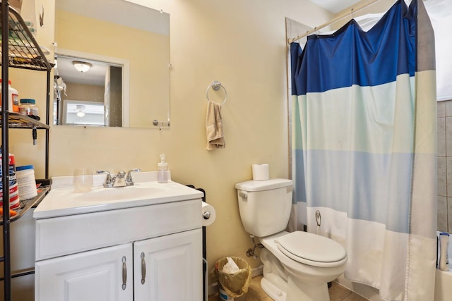 bathroom with tile patterned floors, a shower with curtain, vanity, and toilet