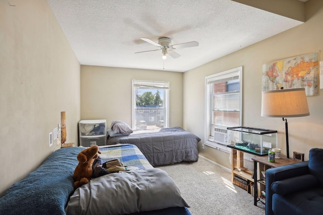 bedroom featuring cooling unit, ceiling fan, carpet, and a textured ceiling