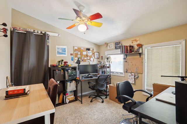 carpeted office with a textured ceiling, ceiling fan, and vaulted ceiling