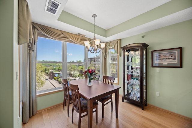 630 Main St N Unit 202, Stillwater, MN 55082 - dining area with a chandelier, healthy amount of natural light, light wood-type flooring, and baseboards