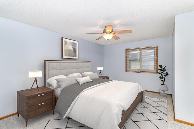 bedroom featuring ceiling fan and a textured ceiling