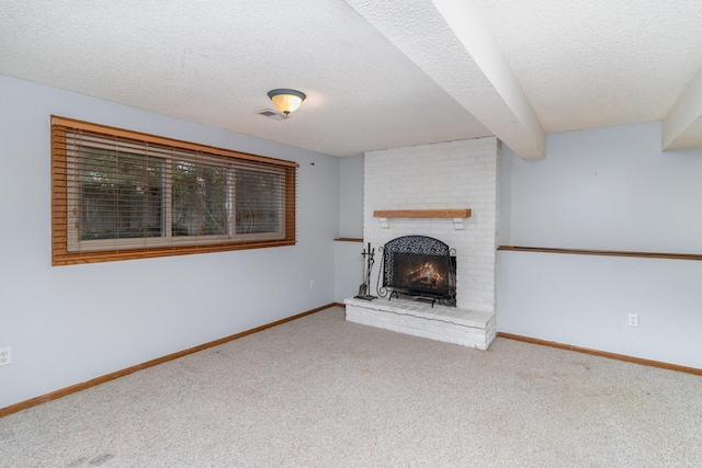 unfurnished living room featuring a brick fireplace, a textured ceiling, and light carpet