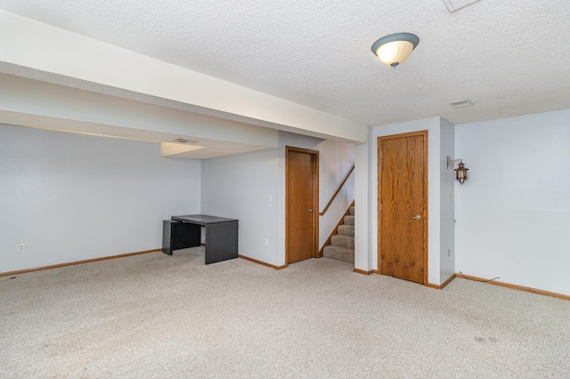 basement with carpet and a textured ceiling