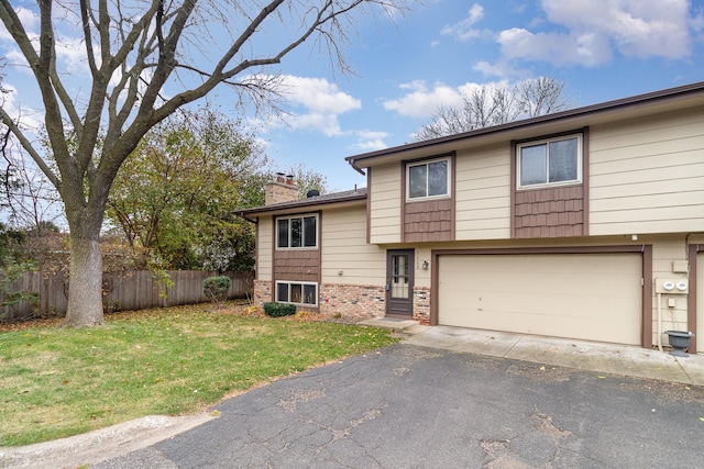 view of front of home with a front lawn and a garage