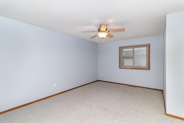 carpeted empty room with ceiling fan and a textured ceiling