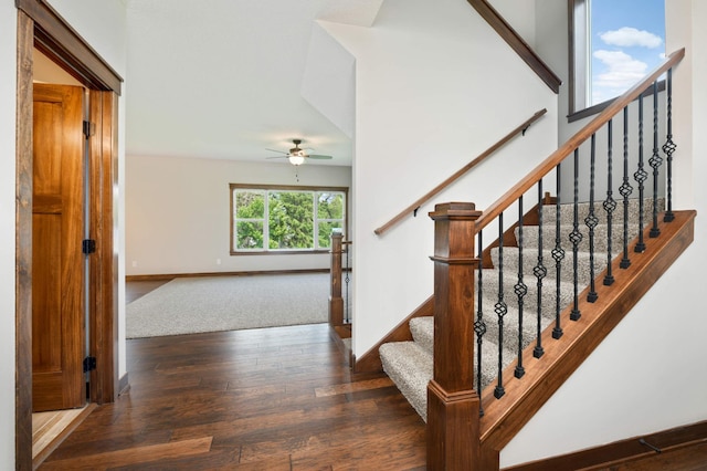 stairs featuring hardwood / wood-style flooring and ceiling fan