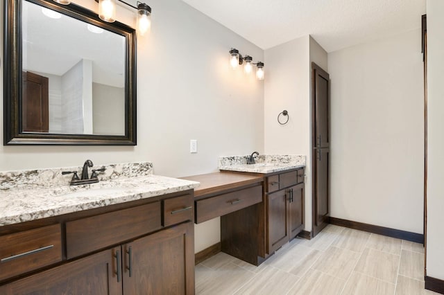 bathroom with vanity and a textured ceiling