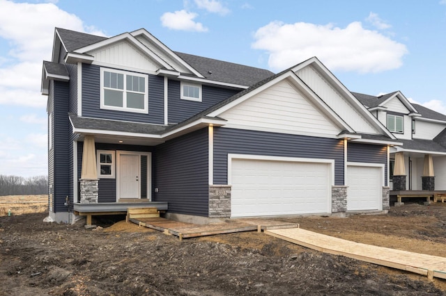 craftsman-style house with a garage, dirt driveway, a shingled roof, and board and batten siding