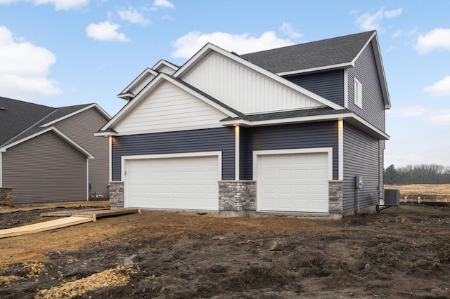 view of front of home with a garage and roof with shingles