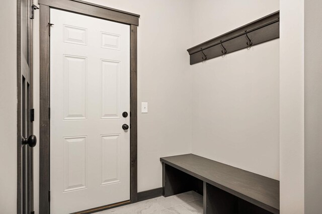 mudroom with marble finish floor and baseboards