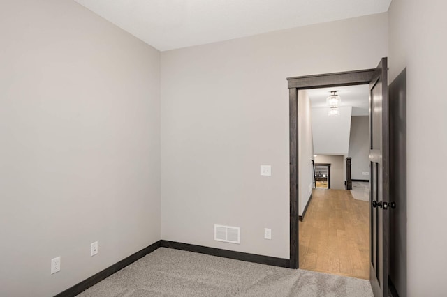 unfurnished room featuring visible vents and baseboards