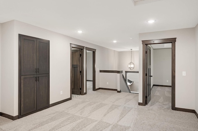 interior space with recessed lighting, baseboards, and light colored carpet